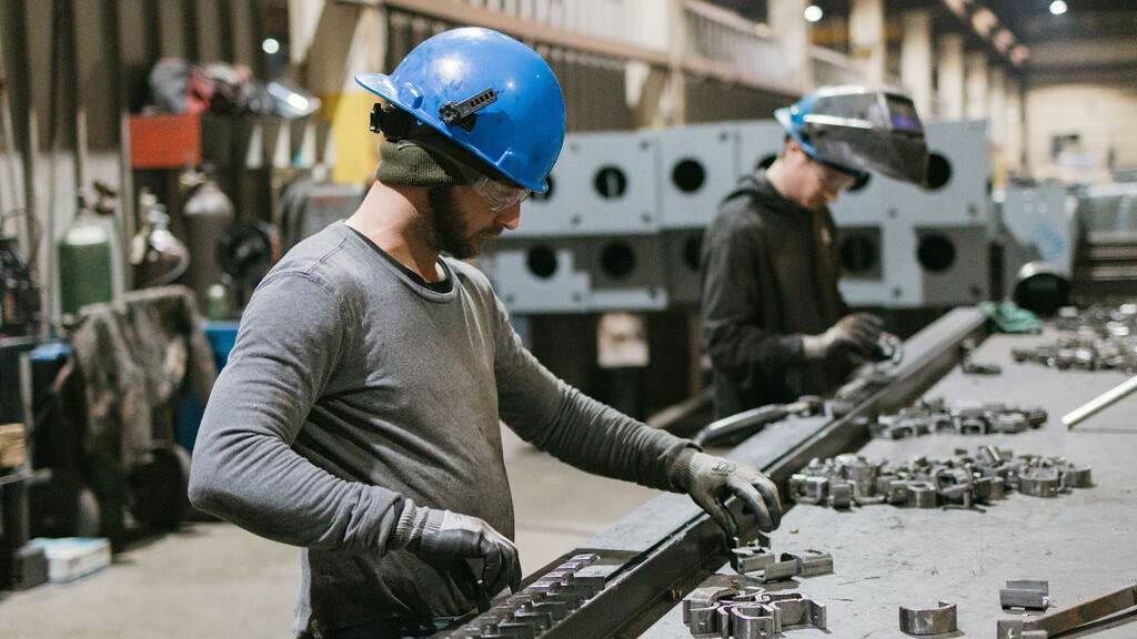 Two TFC workers working to fabricate canopy parts.