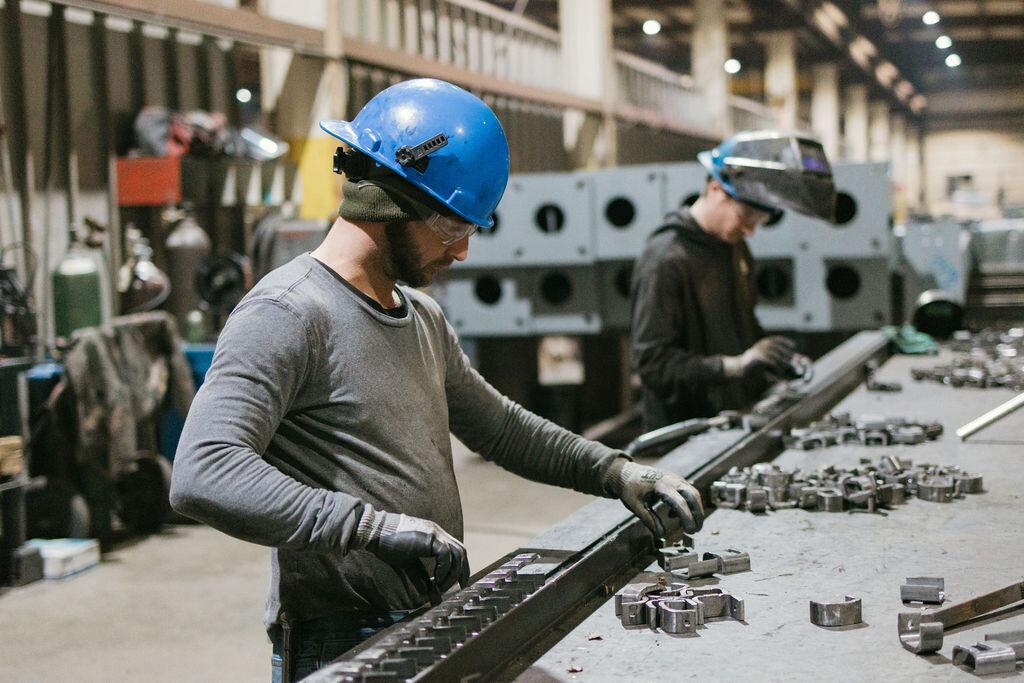 Two TFC workers working to fabricate canopy parts.