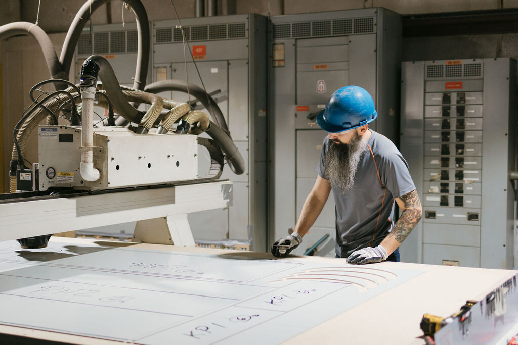 TFC shop employee fabricating material.