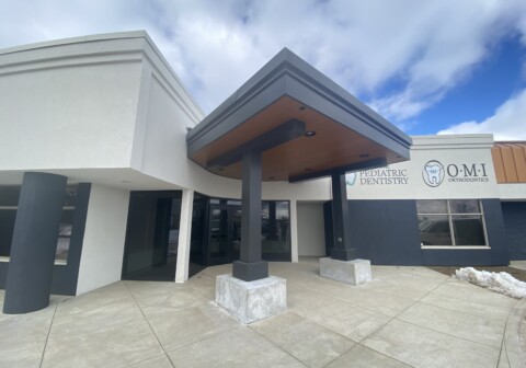 Architectural canopy with MCM wood grain paneling built by TFC.