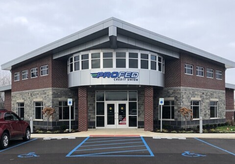 Silver wall panels designed, fabricated, and installed by TFC for a commercial bank.