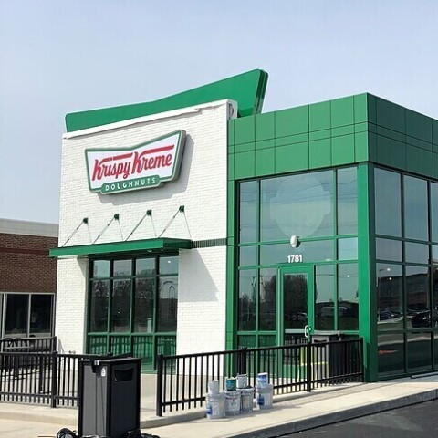 Green mcm wall paneling installed by TFC on a Krispy Kreme building.