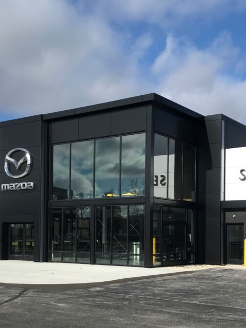 Wall paneling designed, fabricated, and installed by TFC on a car dealership.