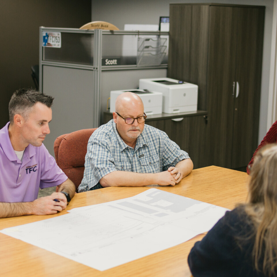 TFC employees analyzing designs.